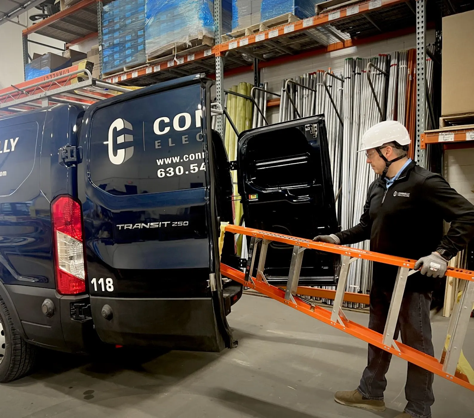 Connecting you with Service & Maintenance A Connelly Electric Maintenance technician loading a ladder into the service van.